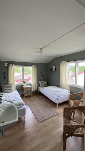 a large bedroom with two beds and a sink at Hovstø Hytter & Rom in Seljord