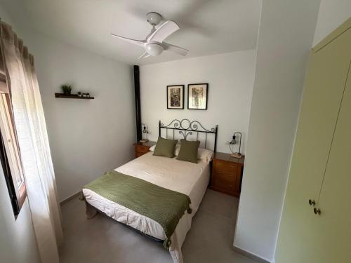 a bedroom with a bed and a ceiling fan at Casa Chica in Cazorla
