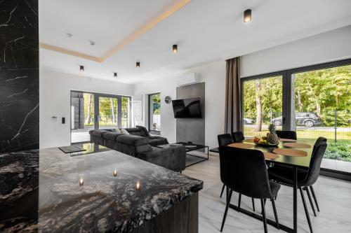 a living room with a couch and a table at Marina Dziwnów Premium Haus 2 in Dziwnów