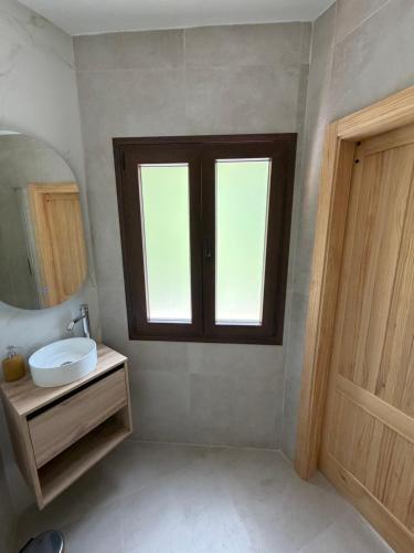 a bathroom with a sink and a window at Casa Chica in Cazorla