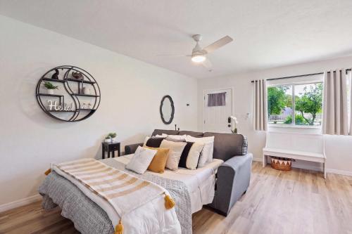 a bedroom with a bed and a couch and a window at The YinYang - King Bed , Workspace , Full Kitchen in Gainesville