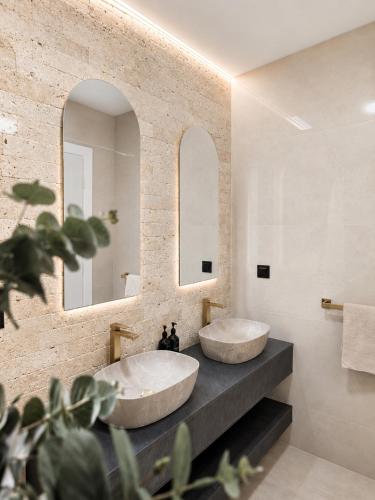 a bathroom with two sinks and a mirror at LUXIA PRIVATE ESTATE Sauna & Pool x Jacuzzi with Fireplace outdoor lounge in Bihać