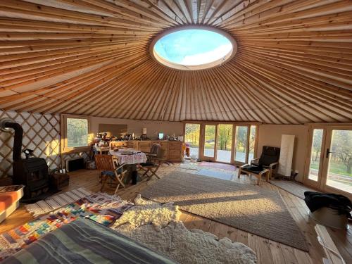 a large room with a ceiling with a round window at Káli Jurta in Tapolca