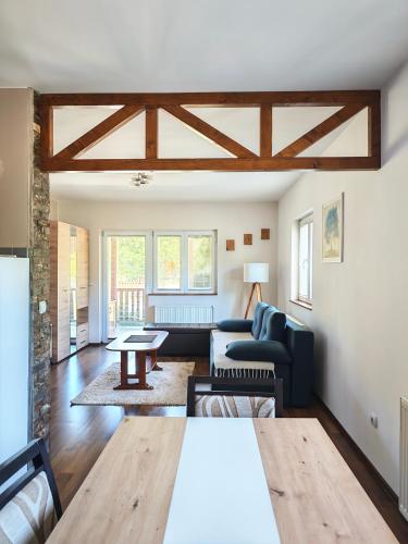 a living room with a couch and a table at Vila Petar Mokra Gora in Mokra Gora