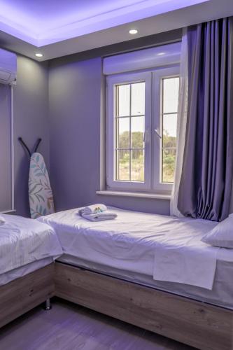 a bedroom with a large bed and a window at Türkmen Villa in Belek