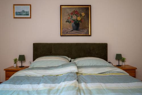 a bedroom with a bed with a painting on the wall at Naturidyll Lavantall in Lading