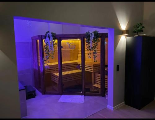 a room with an open door with purple lighting at Luxus Spa Wellness Apartment in Heiligenhaus