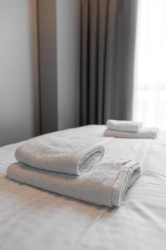 two towels sitting on top of a bed at Апарт-готель Select in Lviv
