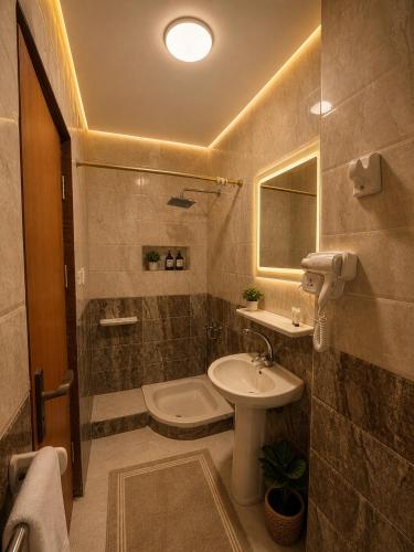 a bathroom with a sink and a toilet and a sink at Lava pyramids hotel in Cairo