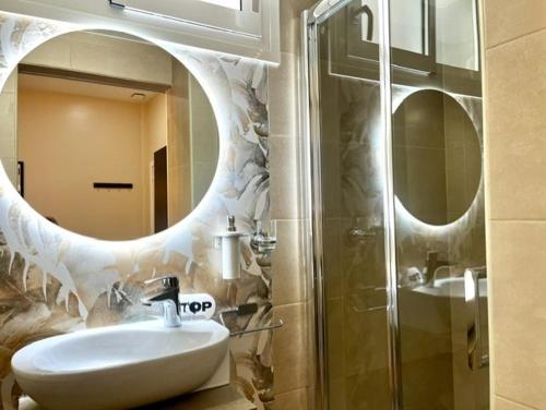 a bathroom with a white sink and a mirror at Front Arc in Barcelona
