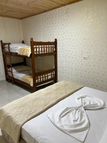 a bedroom with two bunk beds with white sheets at Aldo House in Prekal