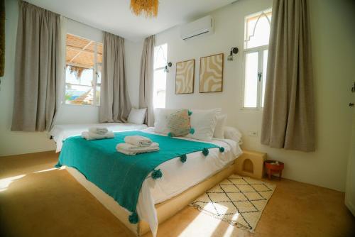 a bedroom with a bed with towels on it at Villa Aloe Vera Privée in Essaouira