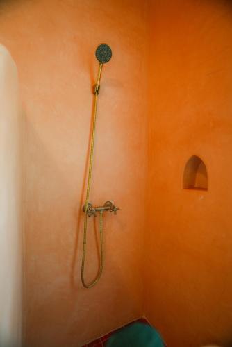 a shower with a hose on a wall at Villa Aloe Vera Privée in Essaouira