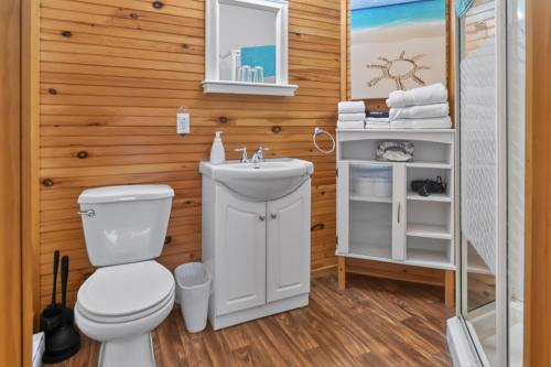 a bathroom with a toilet and a sink at Pepperell Place Inn Inc. in St. Peter's