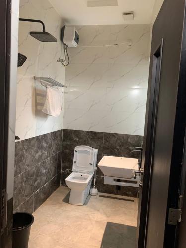 a bathroom with a toilet and a sink at Charles Stainless Hotels in Abakaliki