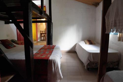 a room with two bunk beds and a table at Onda Verde Hostel in San Salvador de Jujuy