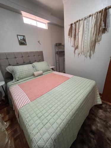 a bedroom with a large bed in a room at Wiracocha Apartments #1 in Cusco