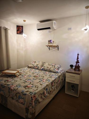 a bedroom with a bed and a dresser and a bed sidx sidx at Suíte cine centro in Garanhuns