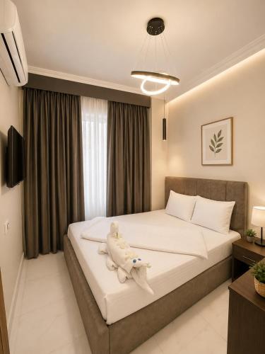 a bedroom with a bed with a stuffed animal on it at Sun Hotel in Cairo