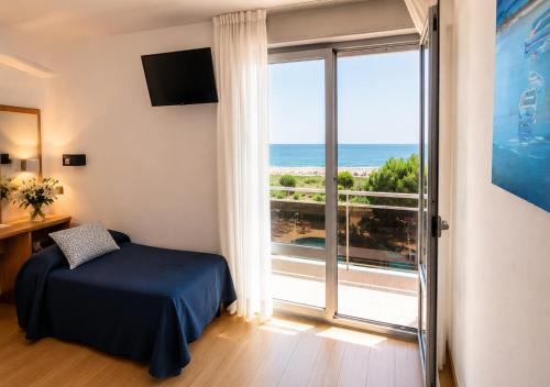 a bedroom with a bed and a view of the ocean at Hotel Bertha Fronte Mare in Lido di Jesolo