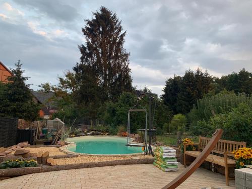 a swimming pool with a slide in a backyard at Acorn Pool Tented Camp in Nidda