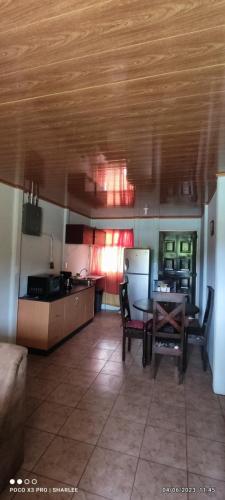 a living room with a table and a kitchen at Casa Amarilla in San Blas