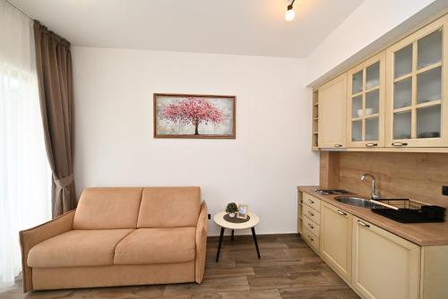 a living room with a couch and a table in a kitchen at Casa Nuova in Kotor