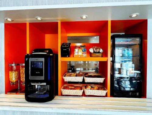 a coffee machine and some donuts in a store at HubOne3 Istres in Istres
