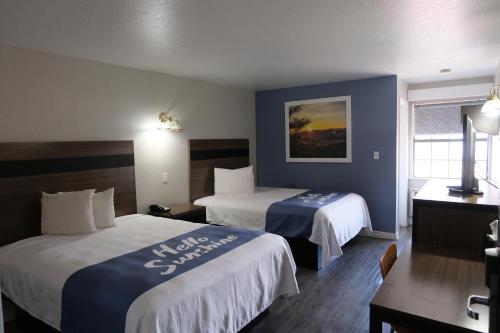 a hotel room with two beds and a window at La Villita Inn in San Antonio