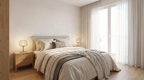 a white bedroom with a bed and a window at Brown Porto Apart in Porto