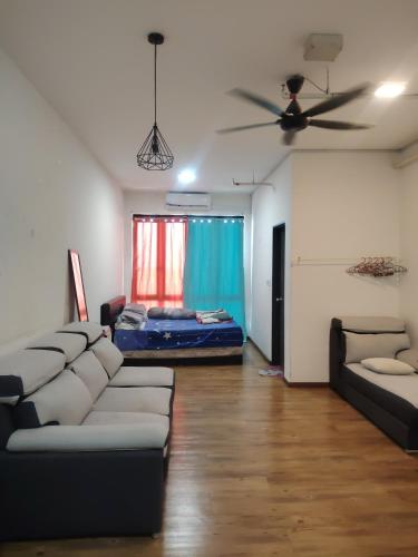 a living room with a couch and a ceiling fan at Suria jaya studio condo shah alam in Shah Alam