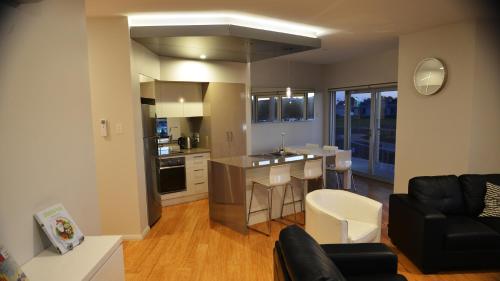 a kitchen and living room with a couch and a table at Robe Marina Accommodation in Robe