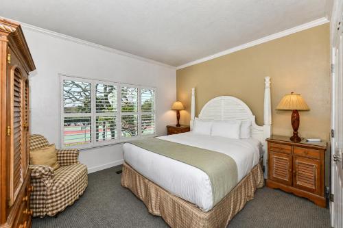 a bedroom with a bed and a chair and a window at Spacious 2BR condo with pool, fireplace,at Silverado Country Club in Napa