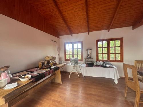 a large room with a table in a room with windows at Hotel Turi Atacama in San Pedro de Atacama