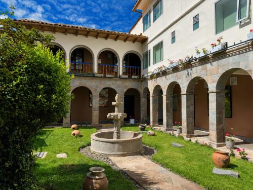 a courtyard with a fountain in front of a building at Ecoterra Essentials San Blas in Cusco