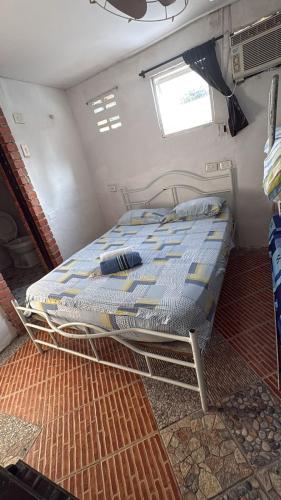 a bedroom with a bed in a small room at Hostal #10-33 in Cartagena de Indias