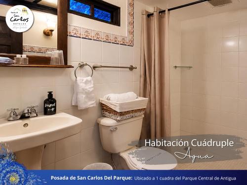 a bathroom with a shower and a toilet and a sink at Posada de San Carlos del Parque in Antigua Guatemala