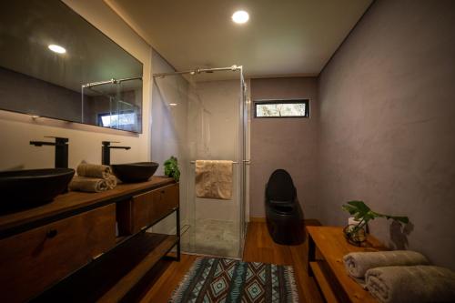 a bathroom with a glass shower and a sink at Kavas Natural Connection in Salento