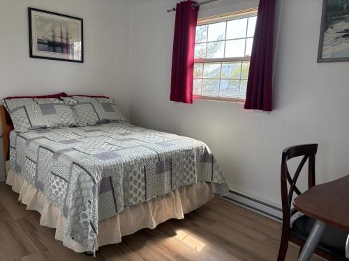 a bedroom with a bed and a table and window at Three bedrooms cozy home in Sydney