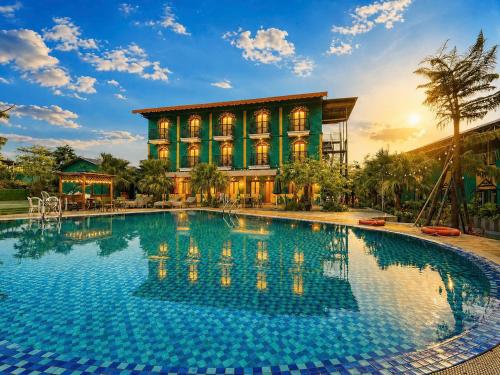 a large swimming pool in front of a building at Minh Chau Beach Resort in Quang Ninh