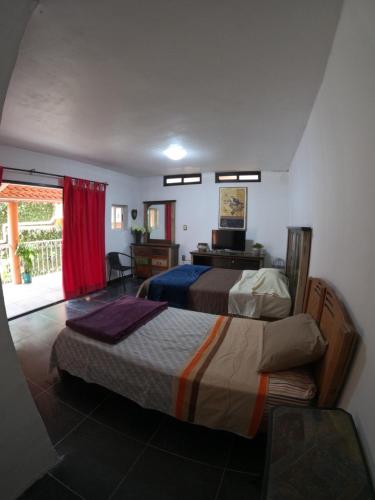 a bedroom with two beds and a television in it at Casa León in Orizaba
