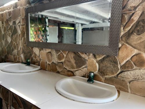 a bathroom counter with two sinks and a mirror at AcapulcoBeach in Playa Blanca
