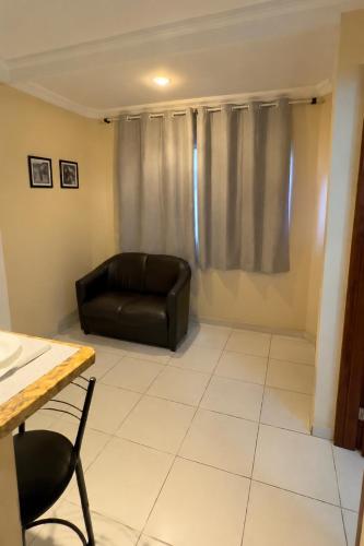 a living room with a couch and a table at Sossai Hostel Flats in Vitória
