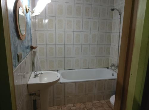 a bathroom with a bath tub and a sink and a bath tub at Cabaña Chaicura in Ancud