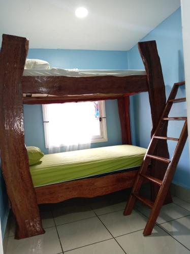 a bunk bed in a room with a ladder at PuertoViejo in Puerto Viejo