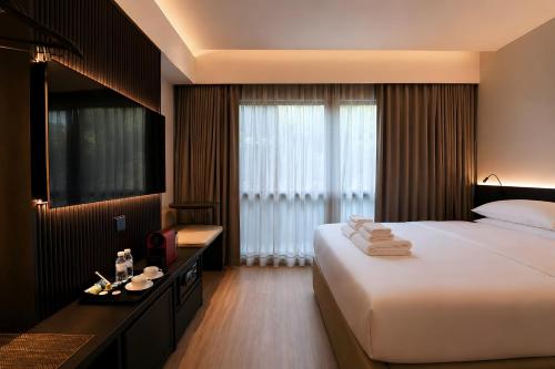a hotel room with a large bed and a window at Link Hotel Singapore in Singapore