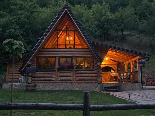 a log cabin with a large window at Brvnara Floridita u prirodi - blizu Manastira Tavna in Ugljevik