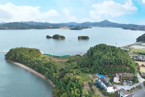 an island in the middle of a body of water at Taean Napoli Pension in Seosan