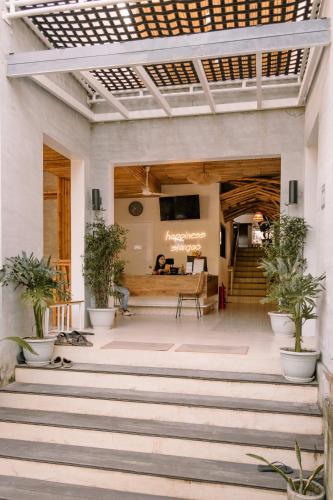 a lobby of a building with potted plants at Happiness Hostel Siargao in General Luna