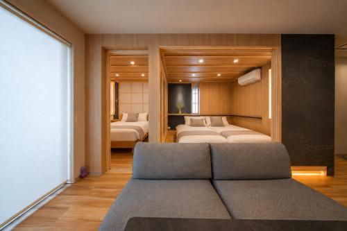 a living room with two beds and a couch at Sugamo Winco Residence 新宿まで電車14分 巣鴨駅徒歩3分 光wifi エレベーター 商店街徒歩4分 in Tokyo